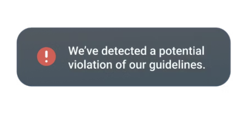 A warning icon indicating a potential violation to community guidelines was flagged
