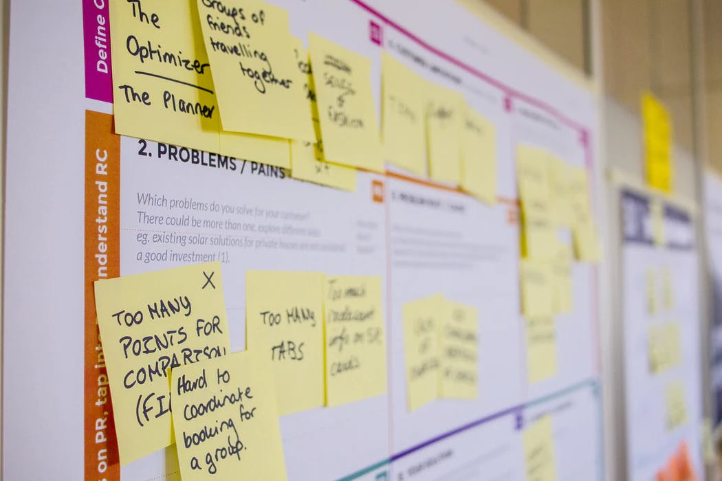 product plan grid on whiteboard with yellow post it notes