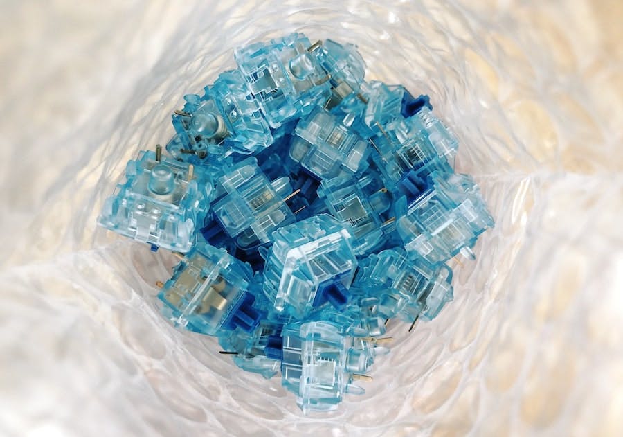 closeup of translucent blue component wiring connectors in a bubblewrap bag